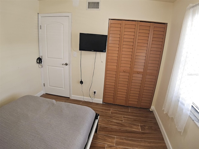 10003 Winding Lake Rd Unit 105, Sunrise, FL 33351 - bedroom featuring wood finished floors, a closet, and baseboards