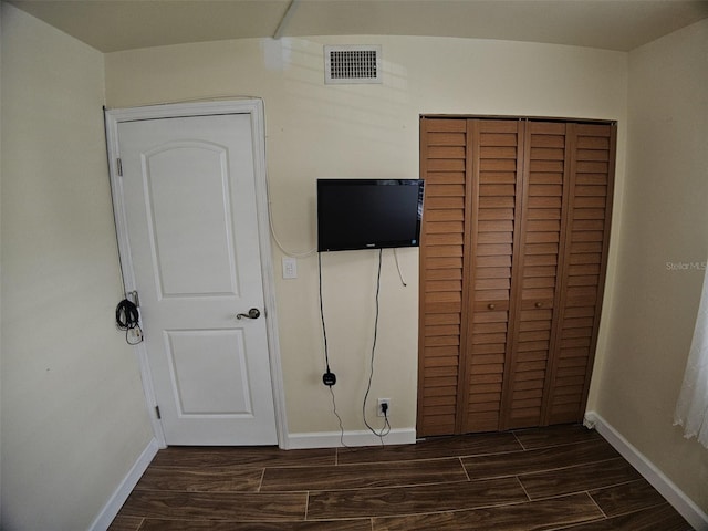 10003 Winding Lake Rd Unit 105, Sunrise, FL 33351 - unfurnished bedroom featuring baseboards, dark wood-style floors, and a closet