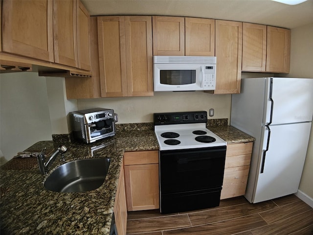 10003 Winding Lake Rd Unit 105, Sunrise, FL 33351 - kitchen with white appliances, a sink, wood finish floors, light brown cabinetry, and dark stone counters