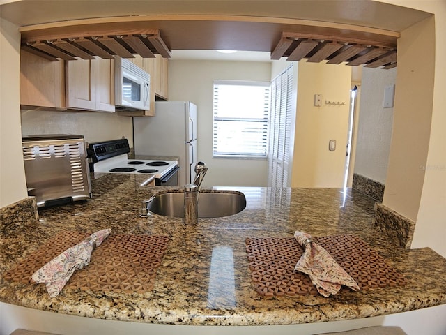 10003 Winding Lake Rd Unit 105, Sunrise, FL 33351 - kitchen with range with electric stovetop, white microwave, a sink, and a peninsula