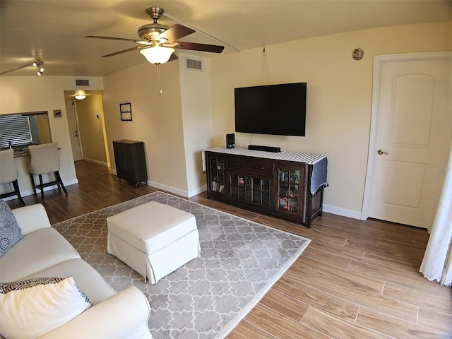 10003 Winding Lake Rd Unit 105, Sunrise, FL 33351 - living area featuring baseboards, ceiling fan, and wood finished floors