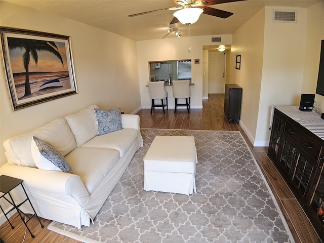 10003 Winding Lake Rd Unit 105, Sunrise, FL 33351 - living area featuring a ceiling fan, wood finished floors, and baseboards
