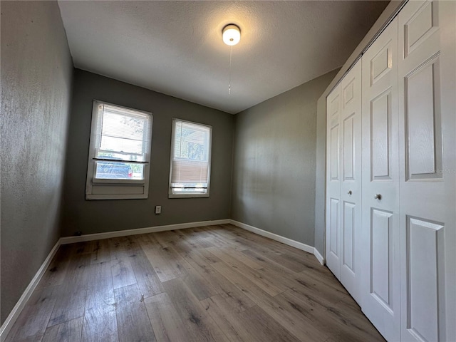 1536 S Martin Luther King Jr Ave, Clearwater, FL 33756 - unfurnished bedroom featuring wood finished floors, baseboards, and a closet