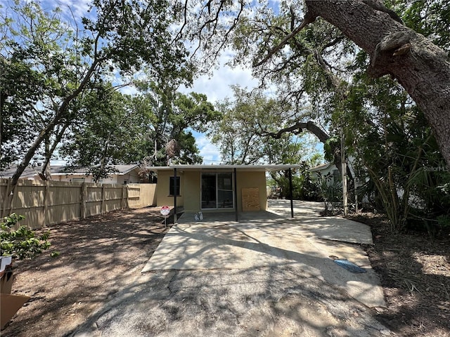 1536 S Martin Luther King Jr Ave, Clearwater, FL 33756 - back of property featuring fence, stucco siding, and a patio area