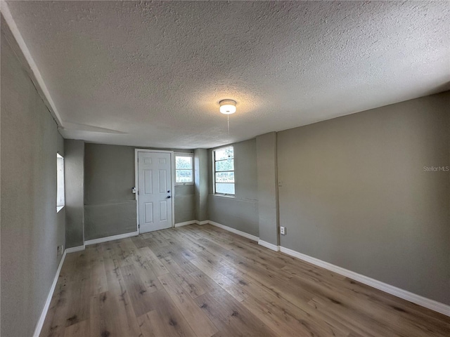 1536 S Martin Luther King Jr Ave, Clearwater, FL 33756 - empty room with a textured ceiling, wood finished floors, and baseboards