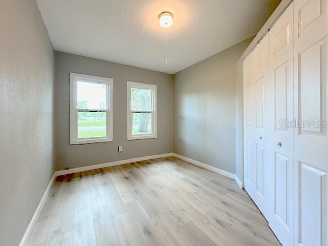 1536 S Martin Luther King Jr Ave, Clearwater, FL 33756 - unfurnished bedroom featuring light wood-type flooring, baseboards, and a closet