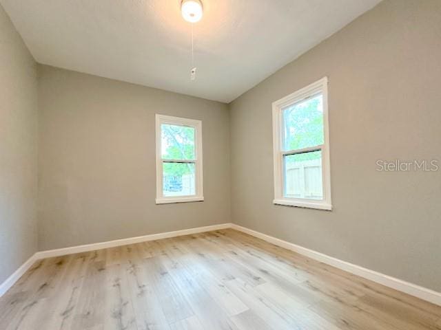 1536 S Martin Luther King Jr Ave, Clearwater, FL 33756 - spare room with healthy amount of natural light, wood finished floors, and baseboards