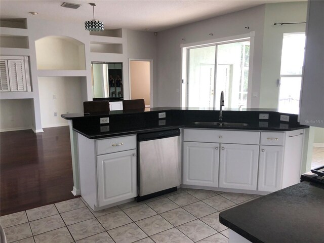 4512 River Overlook Dr, Valrico, FL 33596 - kitchen featuring dishwasher, a sink, dark countertops, and white cabinets