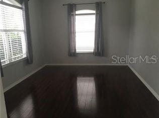 4512 River Overlook Dr, Valrico, FL 33596 - empty room featuring baseboards, plenty of natural light, and wood finished floors
