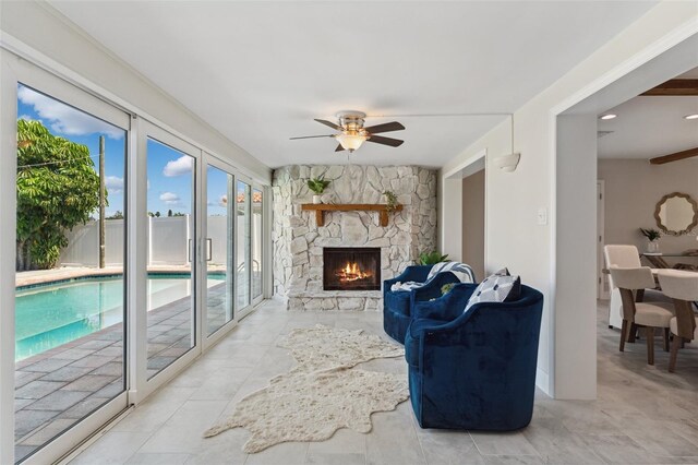 3912 Doral Dr, Tampa, FL 33634 - living room featuring ceiling fan and a stone fireplace