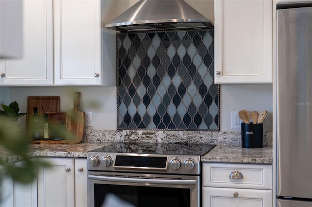 3912 Doral Dr, Tampa, FL 33634 - kitchen with island exhaust hood, stainless steel appliances, white cabinets, and light stone counters