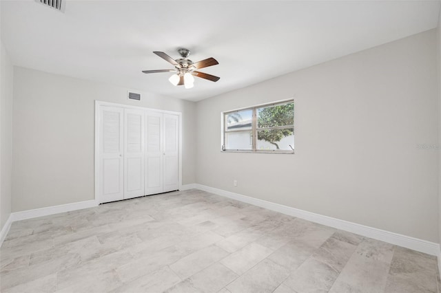 3912 Doral Dr, Tampa, FL 33634 - unfurnished bedroom featuring a closet and a ceiling fan
