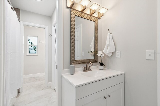 3912 Doral Dr, Tampa, FL 33634 - full bathroom featuring vanity and marble look tiles