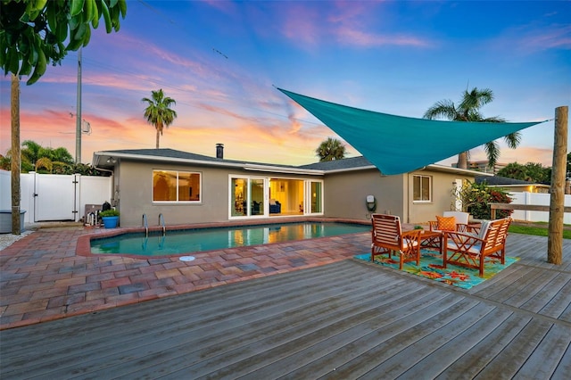 3912 Doral Dr, Tampa, FL 33634 - rear view of house featuring a wooden deck, a fenced backyard, stucco siding, and a gate