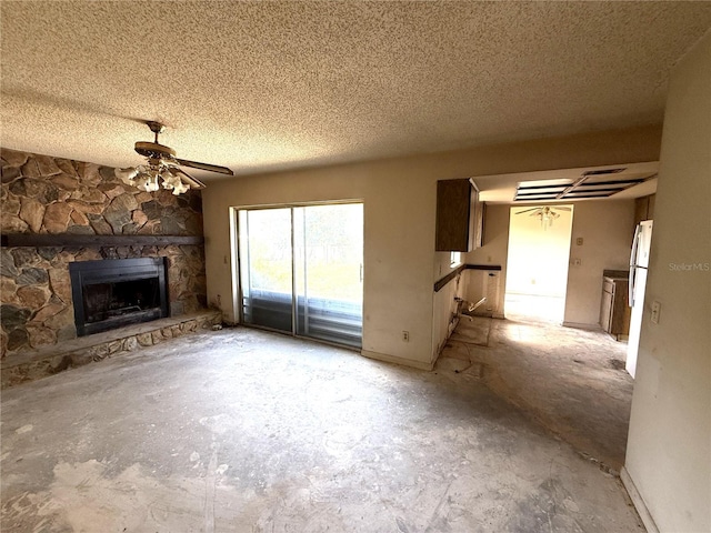 9722 Kenton Rd, Wesley Chapel, FL 33545 - unfurnished living room with a fireplace, a textured ceiling, and ceiling fan