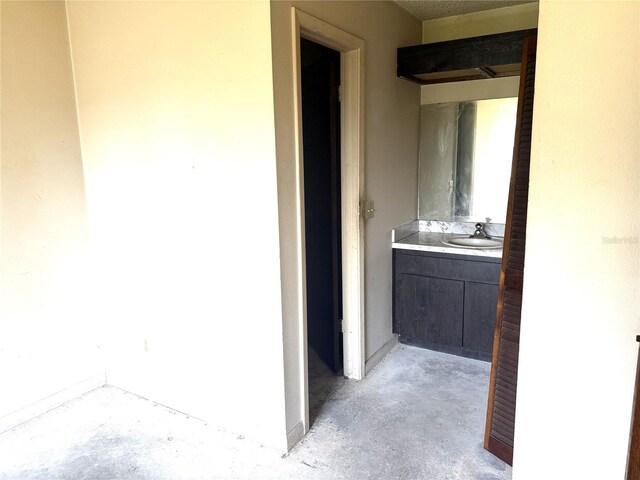 9722 Kenton Rd, Wesley Chapel, FL 33545 - bathroom featuring unfinished concrete flooring, baseboards, and vanity