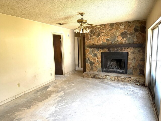 9722 Kenton Rd, Wesley Chapel, FL 33545 - unfurnished living room featuring a fireplace, ceiling fan, concrete floors, and a textured ceiling