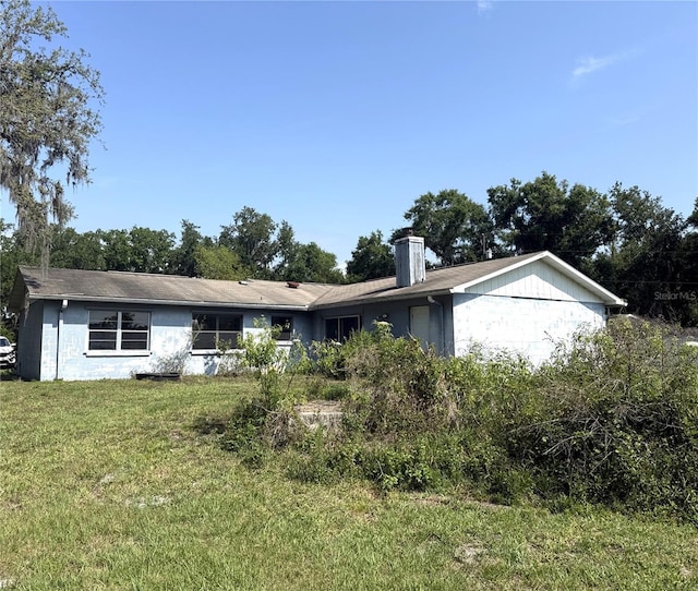 9722 Kenton Rd, Wesley Chapel, FL 33545 - ranch-style home featuring a front lawn and a chimney