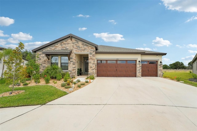 view of front of home featuring stone siding, an attached garage, concrete driveway, a front yard, and stucco siding