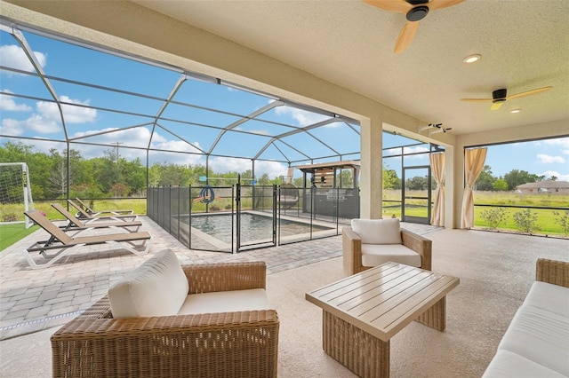 view of patio / terrace featuring ceiling fan, outdoor lounge area, and glass enclosure