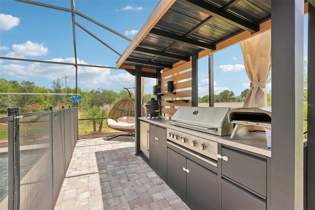 view of patio with area for grilling, grilling area, and a lanai