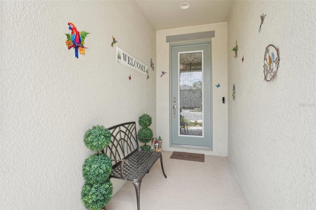 view of exterior entry featuring stucco siding
