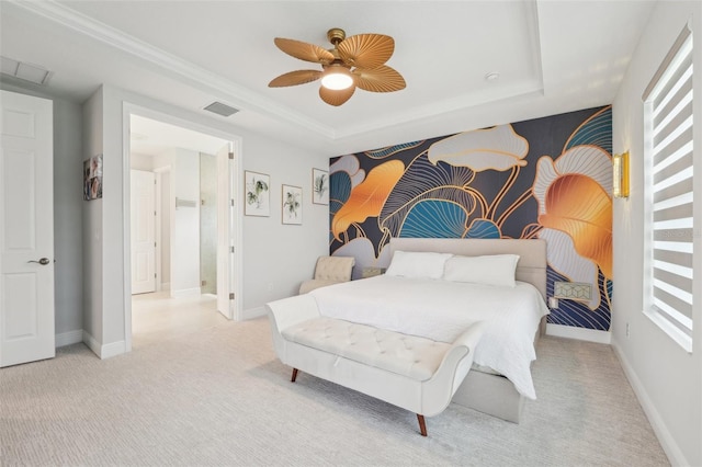 carpeted bedroom with a tray ceiling, baseboards, and a ceiling fan