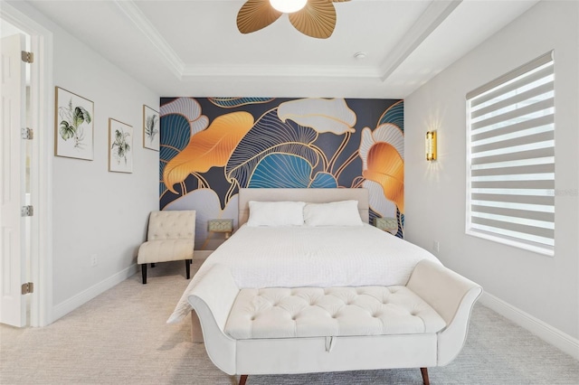 bedroom featuring carpet, a tray ceiling, and baseboards
