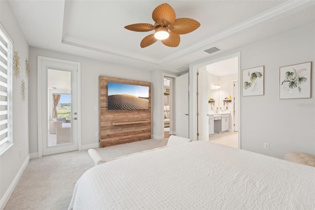 bedroom with access to exterior, light carpet, a tray ceiling, ensuite bathroom, and baseboards