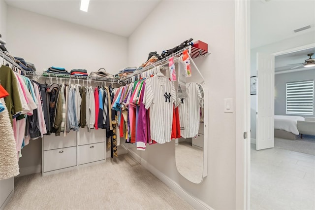 spacious closet featuring carpet flooring and a ceiling fan