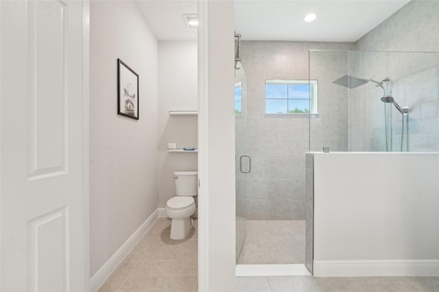 full bath with walk in shower, toilet, tile patterned floors, and baseboards