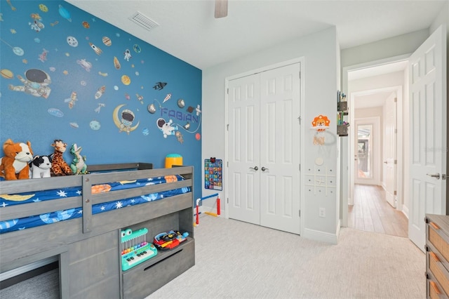 carpeted bedroom featuring a closet, baseboards, and ceiling fan