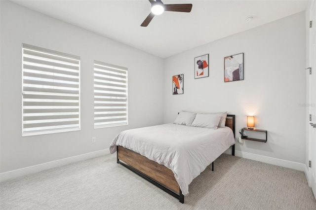 bedroom featuring baseboards, carpet floors, and a ceiling fan