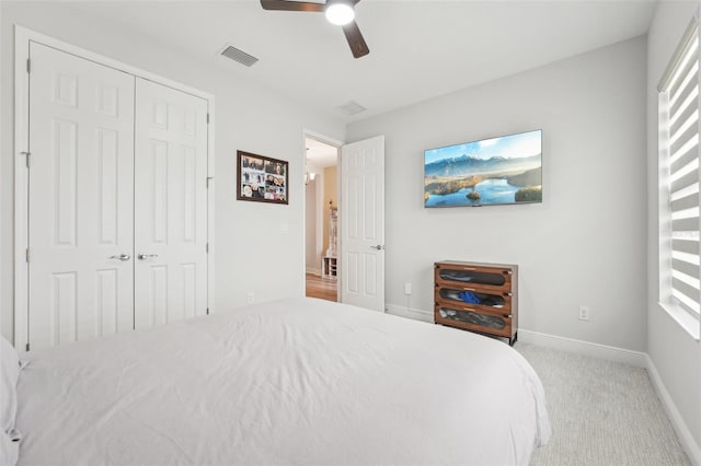 carpeted bedroom featuring baseboards, ceiling fan, and a closet