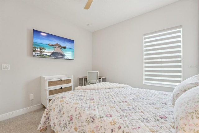 carpeted bedroom featuring baseboards and ceiling fan