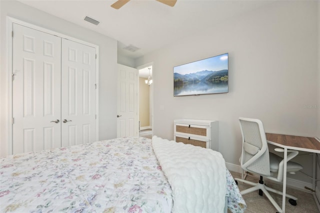 carpeted bedroom with a closet, baseboards, and ceiling fan