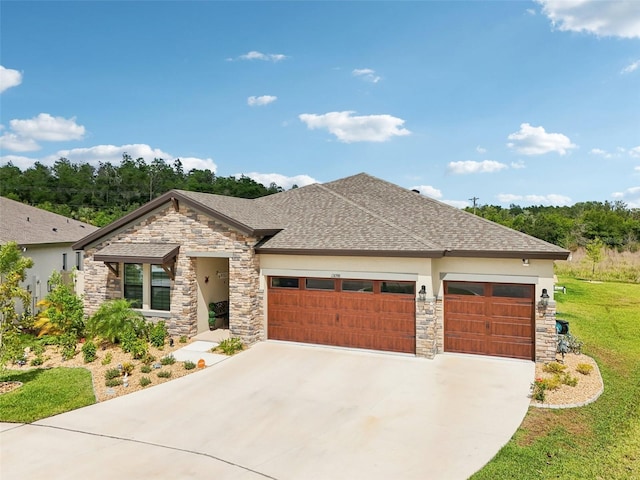 view of front of house with stone siding, a garage, driveway, and a front yard