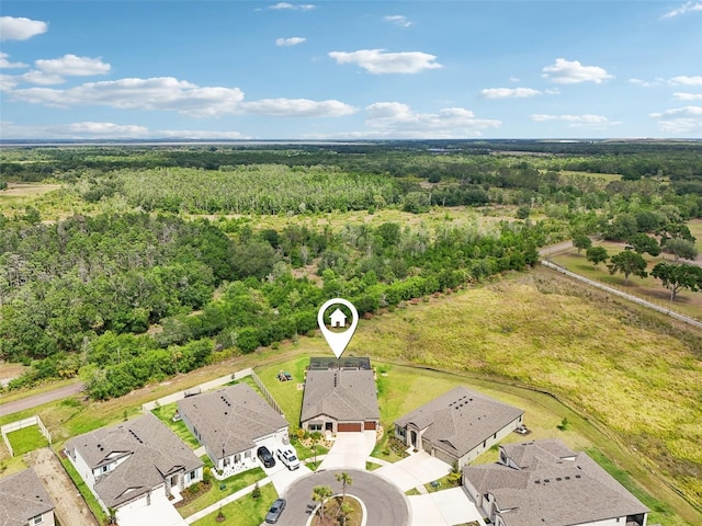 aerial view of residential area featuring a heavily wooded area