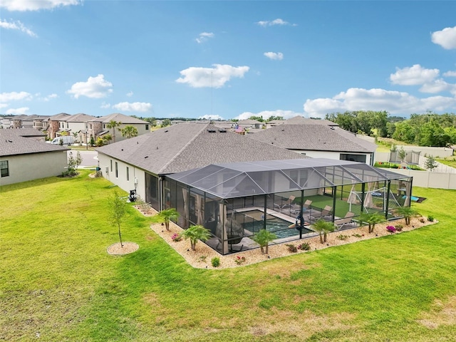 rear view of house with a residential view, an outdoor pool, a patio area, and a lanai