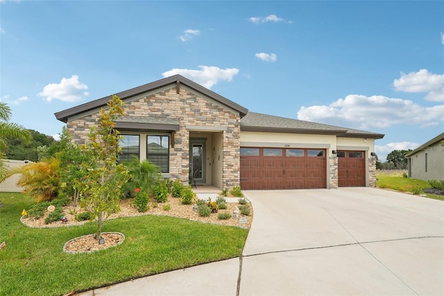 view of front of home with stone siding, a garage, concrete driveway, and a front yard