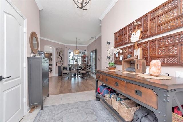 5103 Rushbrook Rd, Land O Lakes, FL 34638 - dining space with crown molding, arched walkways, light tile patterned floors, and baseboards