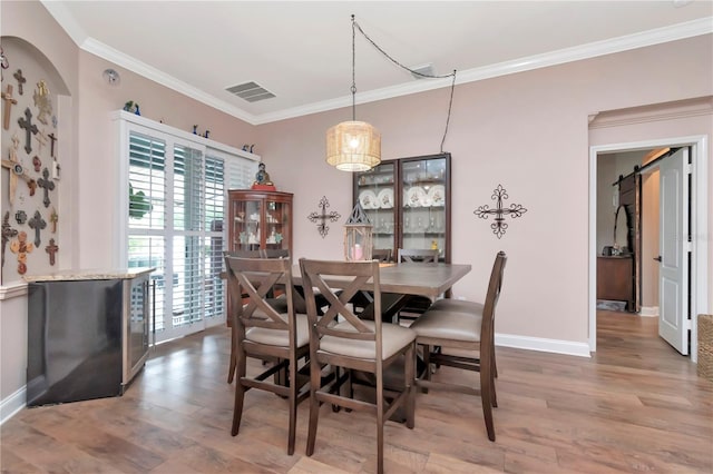 5103 Rushbrook Rd, Land O Lakes, FL 34638 - dining area with ornamental molding, wood finished floors, and baseboards