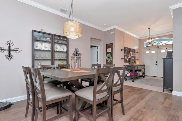 5103 Rushbrook Rd, Land O Lakes, FL 34638 - dining room with wood finished floors, baseboards, ornamental molding, and a chandelier