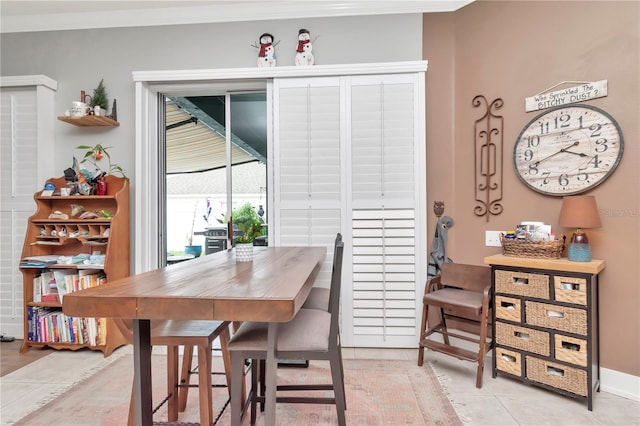 5103 Rushbrook Rd, Land O Lakes, FL 34638 - dining room featuring crown molding, light tile patterned floors, and baseboards