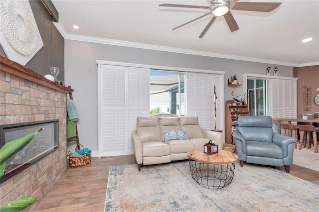 5103 Rushbrook Rd, Land O Lakes, FL 34638 - living area featuring a ceiling fan, crown molding, wood finished floors, a stone fireplace, and recessed lighting