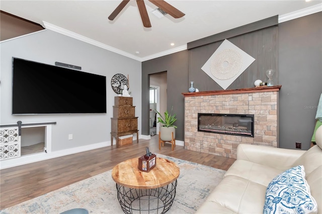 5103 Rushbrook Rd, Land O Lakes, FL 34638 - living area featuring wood finished floors, ceiling fan, crown molding, baseboards, and a fireplace
