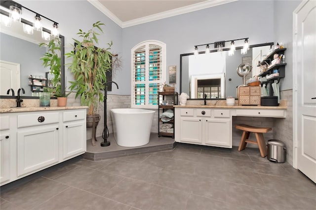 5103 Rushbrook Rd, Land O Lakes, FL 34638 - bathroom with ornamental molding, tile patterned flooring, tile walls, a soaking tub, and a wainscoted wall