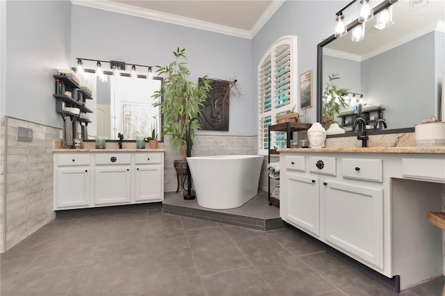 5103 Rushbrook Rd, Land O Lakes, FL 34638 - bathroom with ornamental molding, tile walls, tile patterned floors, a wainscoted wall, and a freestanding tub