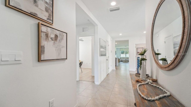 hallway featuring light tile patterned floors, recessed lighting, and baseboards