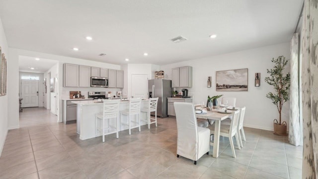 dining area featuring recessed lighting, light tile patterned flooring, and baseboards